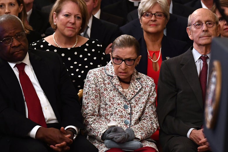 Ginsburg, seated, looks to her right.